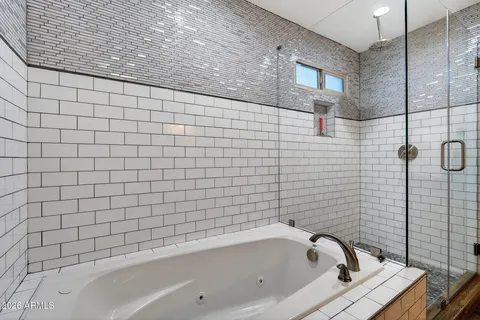 a bathroom with a bathtub and shower