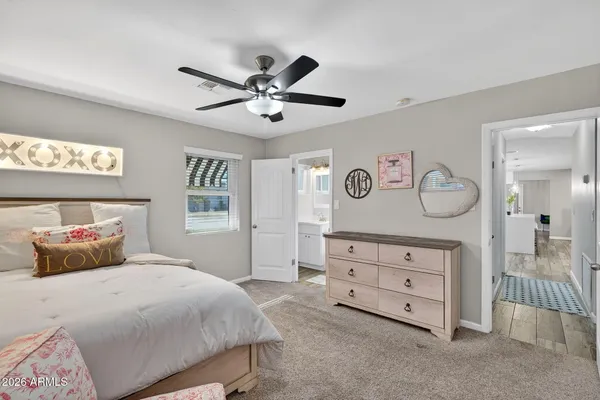 a spacious bedroom with a bed and a couch