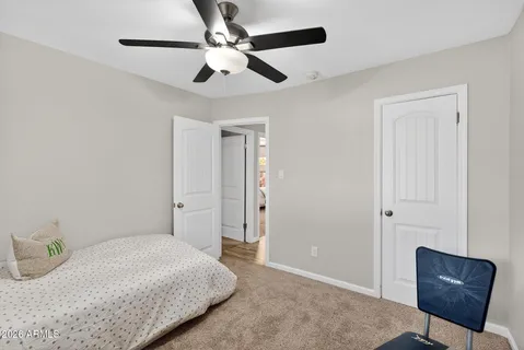 a bathroom with a sink mirror and toilet