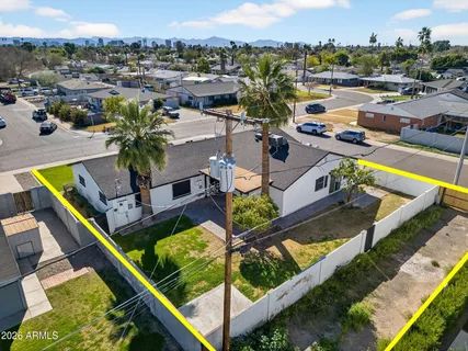 an aerial view of a house with a yard