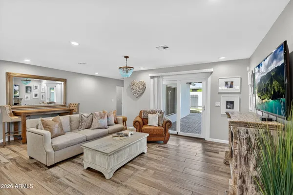 a living room with fireplace furniture and a flat screen tv