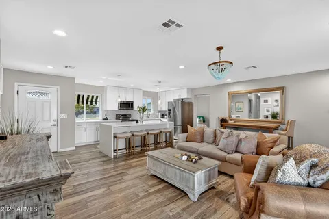 a living room with furniture a flat screen tv and a large window