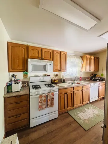 a kitchen with a stove top oven sink and cabinets
