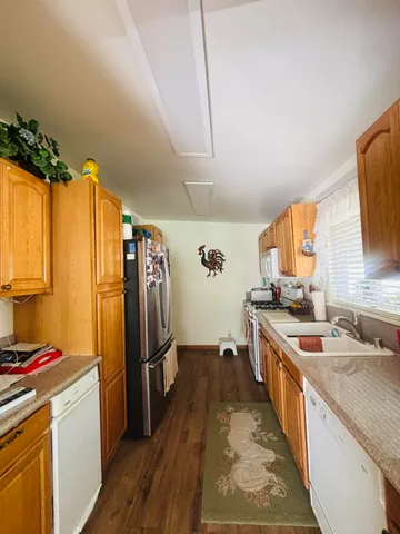 a kitchen with stainless steel appliances granite countertop a sink stove and refrigerator