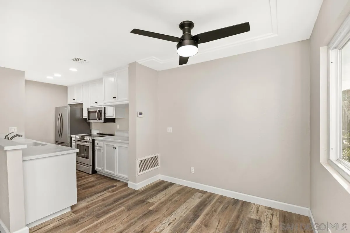 9857 Mission Gorge Road, Unit 2 Santee, CA 92071 - Photo 11 of 11 a kitchen with stainless steel appliances a refrigerator sink and stove