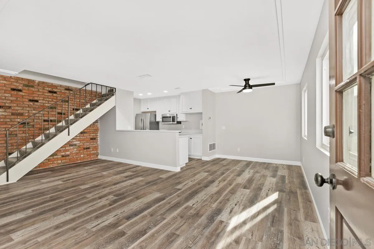 9857 Mission Gorge Road, Unit 2 Santee, CA 92071 - Photo 4 of 11 a view of a kitchen with wooden floor and staircase