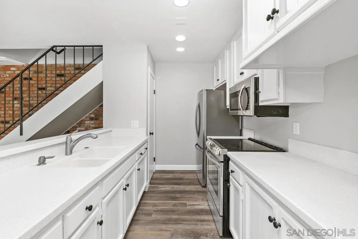 9857 Mission Gorge Road, Unit 2 Santee, CA 92071 - Photo 7 of 11 a kitchen with stainless steel appliances a sink and a refrigerator