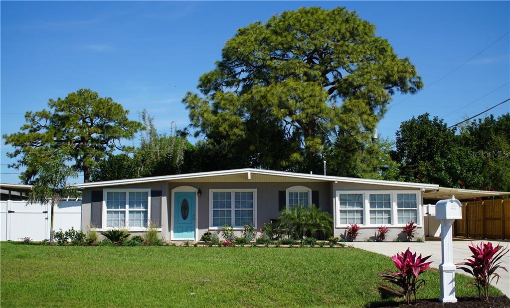 1731 Wharf Road Sarasota, FL 34231 - Photo 1 of 1 a front view of house with yard and green space