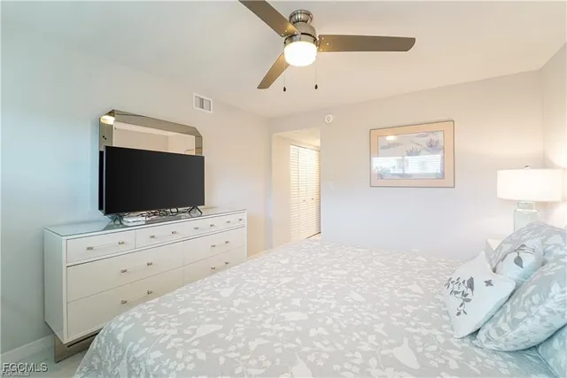 a bedroom with a large bed and a flat screen tv