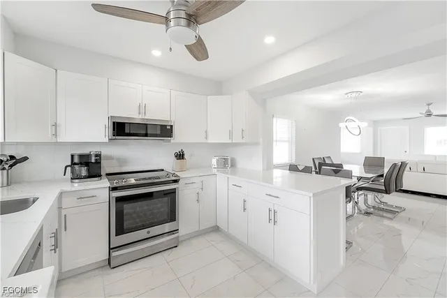 a kitchen with cabinets appliances and a counter top space