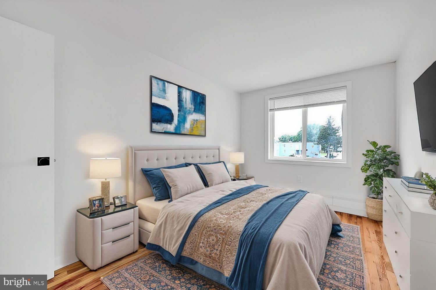 8204 South 82nd Street, Unit A Philadelphia, PA 19153 - Photo 3 of 4 a bed room with a bed and a painting on the wall