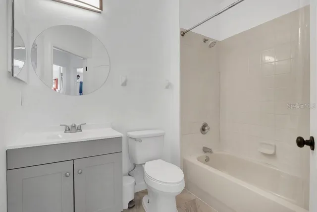 a bathroom with a sink toilet tub and shower