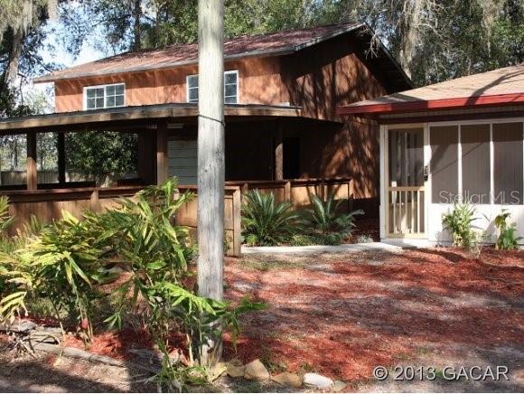 9290 Northeast Ne Highway Bronson, FL 32621 - Photo 1 of 1 a front view of a house with a yard