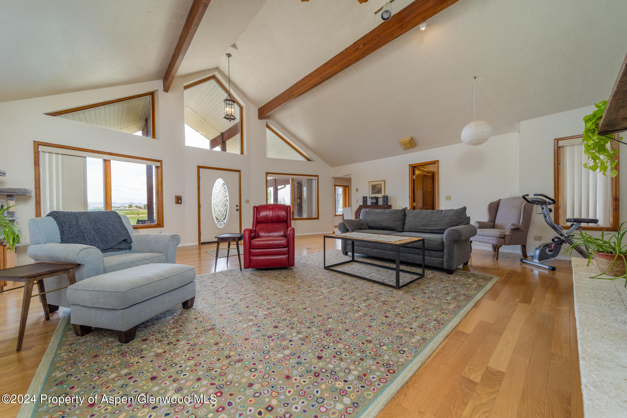 1501 14 Road Loma, CO 81524 - Photo 11 of 27 a living room with furniture a rug and a chandelier