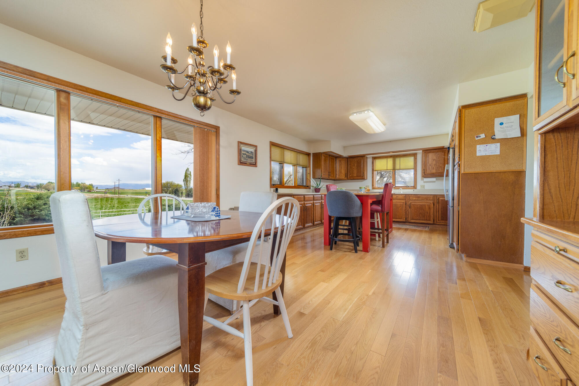1501 14 Road Loma, CO 81524 - Photo 14 of 27 a view of a dining room with furniture a chandelier and wooden floor