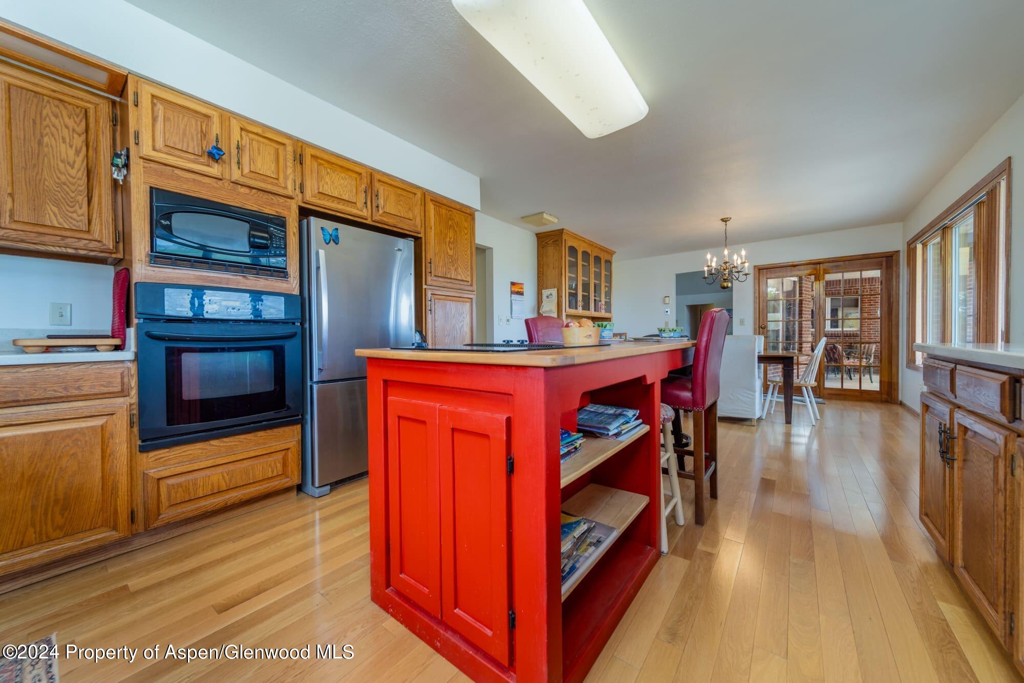 1501 14 Road Loma, CO 81524 - Photo 15 of 27 a view of a living room kitchen with stainless steel appliances wooden floor and living room view