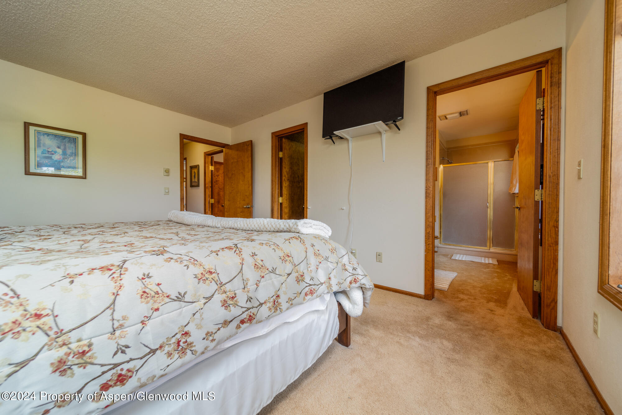 1501 14 Road Loma, CO 81524 - Photo 17 of 27 a spacious bedroom with a bed and a painting on the wall