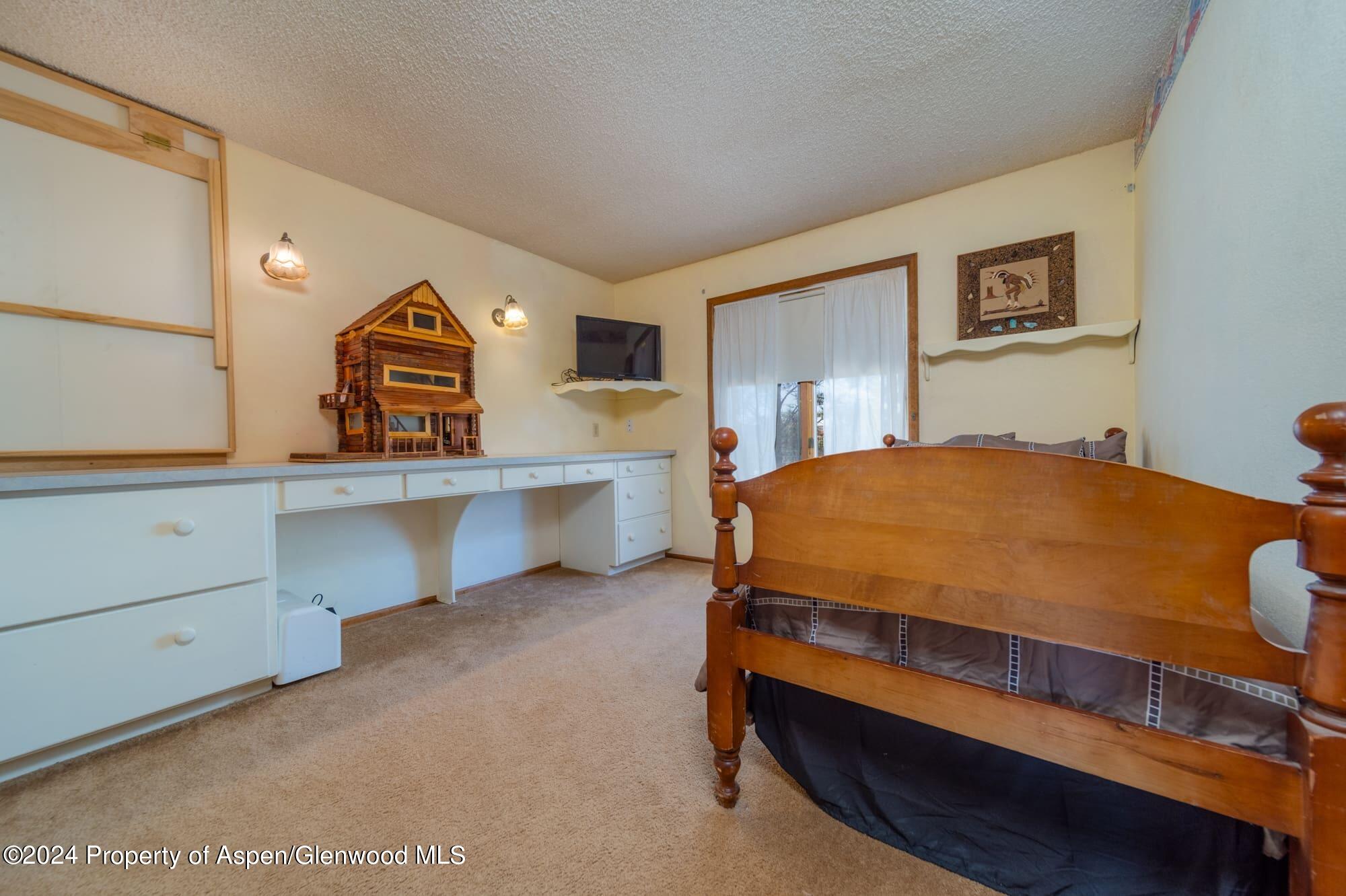 1501 14 Road Loma, CO 81524 - Photo 23 of 27 a bedroom with a bed and a dresser