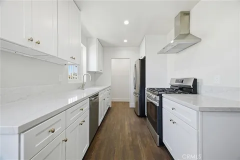 a kitchen with granite countertop cabinets stainless steel appliances and a counter space