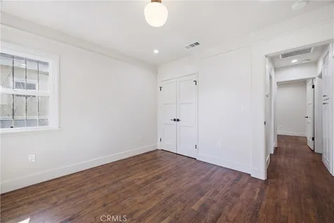 a view of a room with wooden floor and windows
