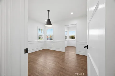 a view of an empty room with window and cabinet