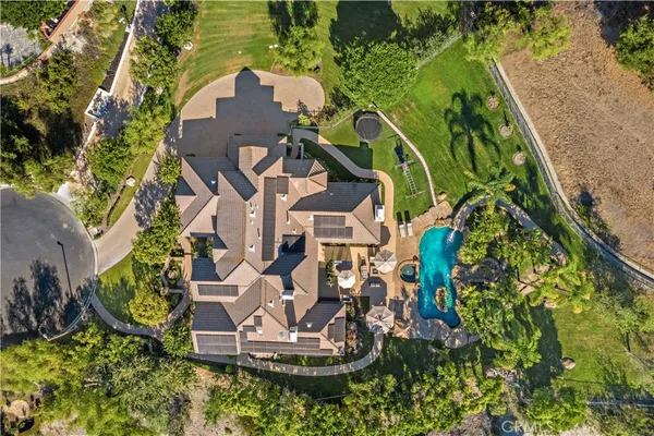 an aerial view of a house with a yard and plants