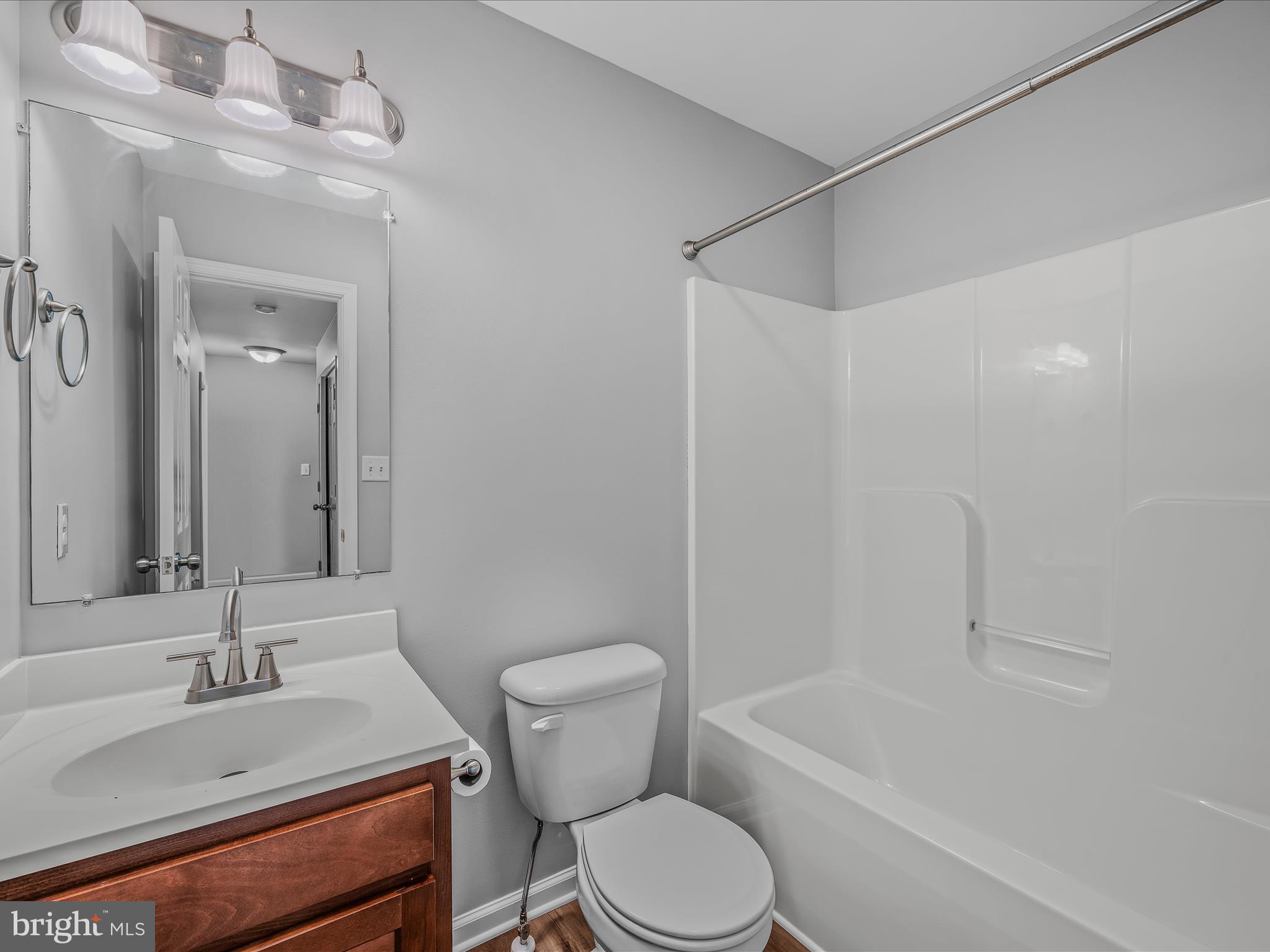 55 Stix Lane Inwood, WV 25428 - Photo 21 of 41 a bathroom with a sink toilet vanity and shower