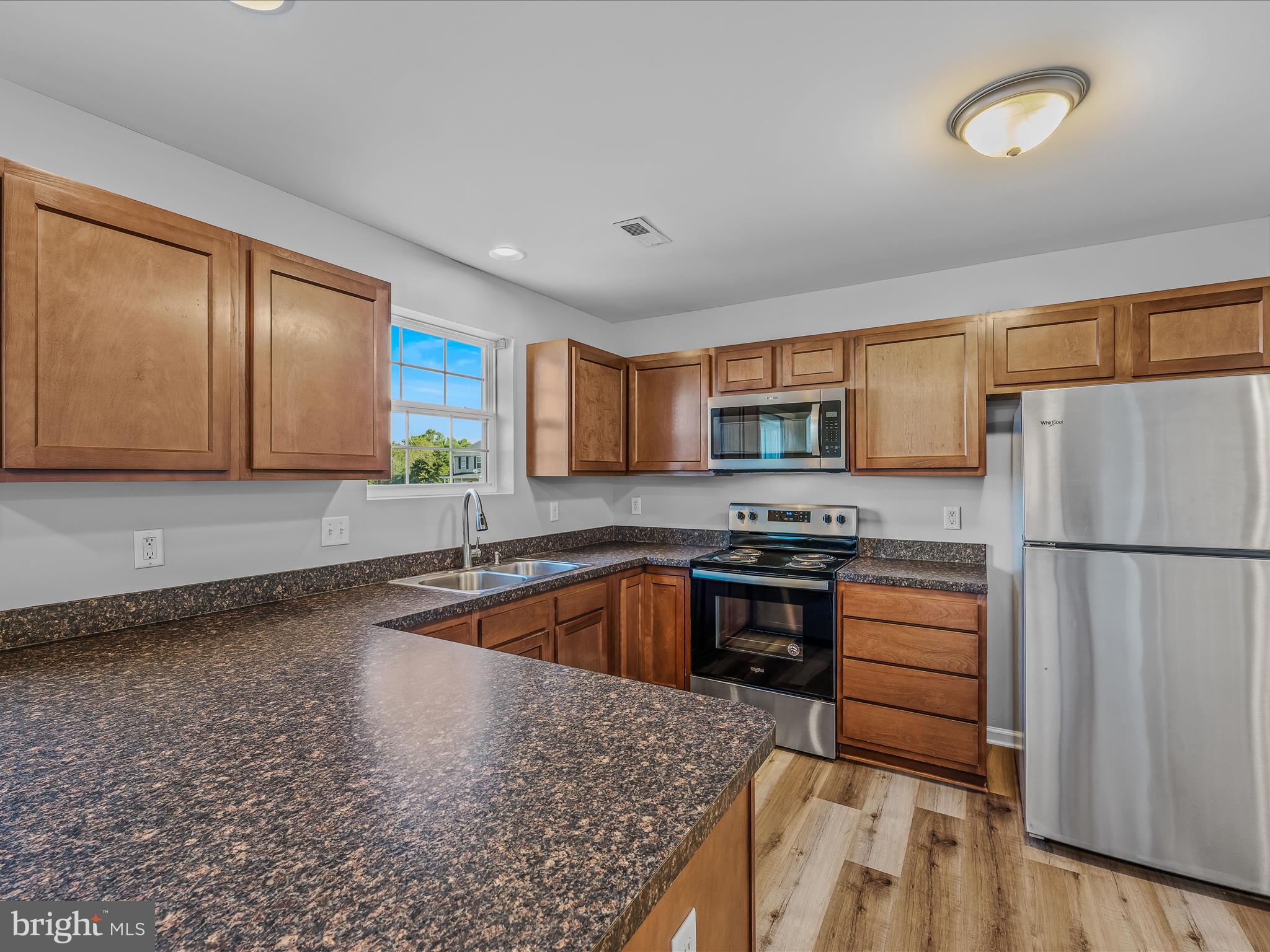 55 Stix Lane Inwood, WV 25428 - Photo 8 of 41 a kitchen with granite countertop a refrigerator and a sink