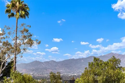 a view of a house with a tree in a yard