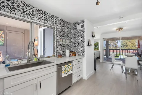a spacious en suite bathroom with a double vanity sink and large mirror