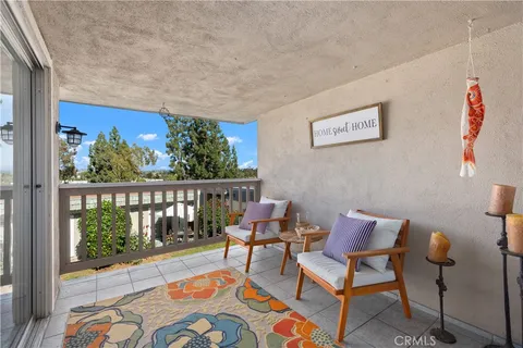 a balcony with furniture and a potted plant