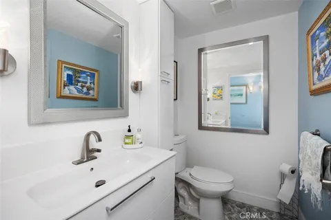 a bathroom with a sink mirror and toilet