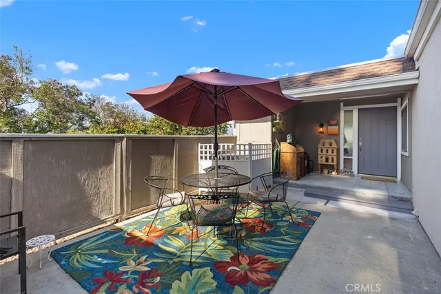 a view of a chairs and table in patio with a barbeque grill