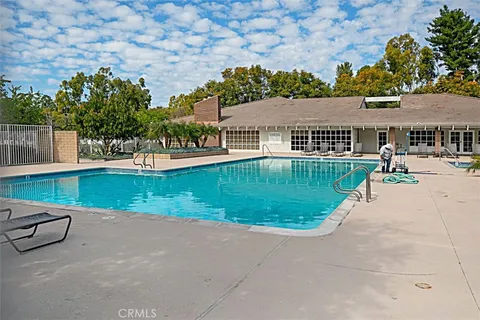 a view of a swimming pool with sitting area and furniture