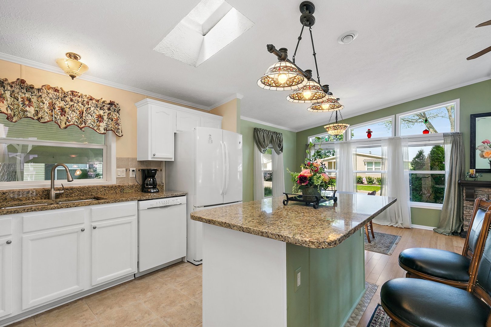 1054 Lakeview Road Elgin, IL 60123 - Photo 11 of 30 a kitchen with stainless steel appliances granite countertop a sink dishwasher a dining table and chairs with wooden floor