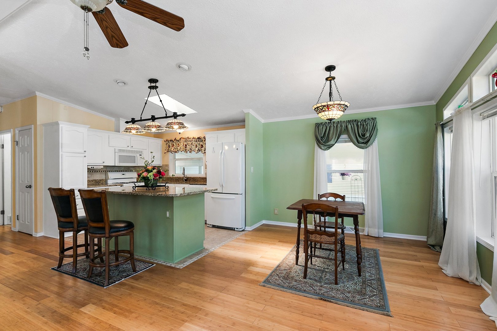 1054 Lakeview Road Elgin, IL 60123 - Photo 8 of 30 a dining room with furniture a chandelier and wooden floor