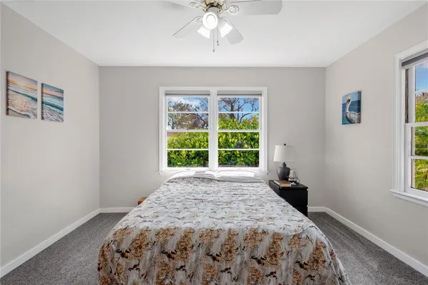 a spacious bedroom with a bed and a window