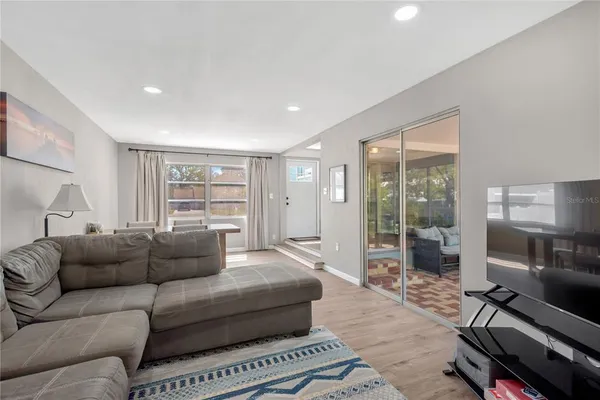a living room with furniture and a floor to ceiling window