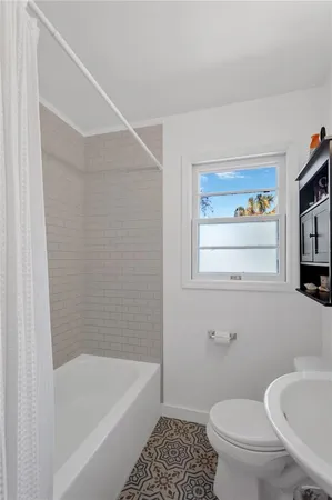 a bathroom with a toilet a sink and bathtub