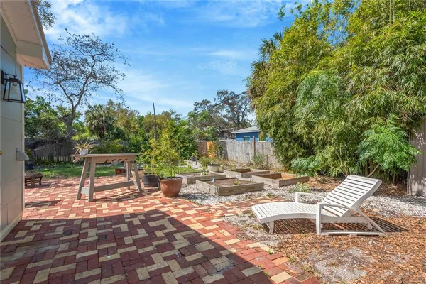 a view of a chairs and tables in the back yard of the house
