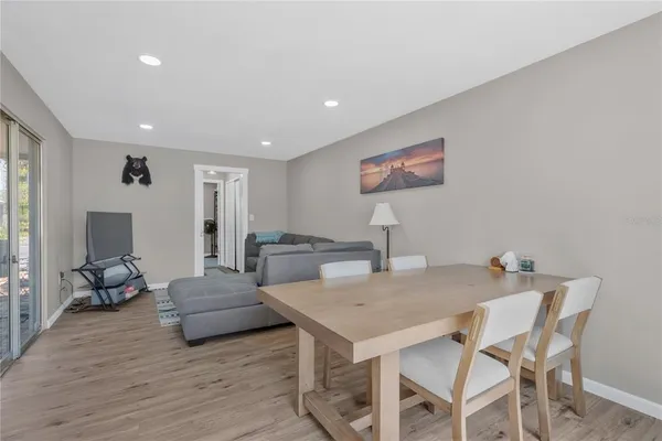 a view of a dining room with furniture and wooden floor