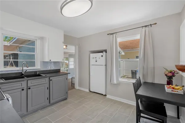 a kitchen with a sink cabinets and wooden floor