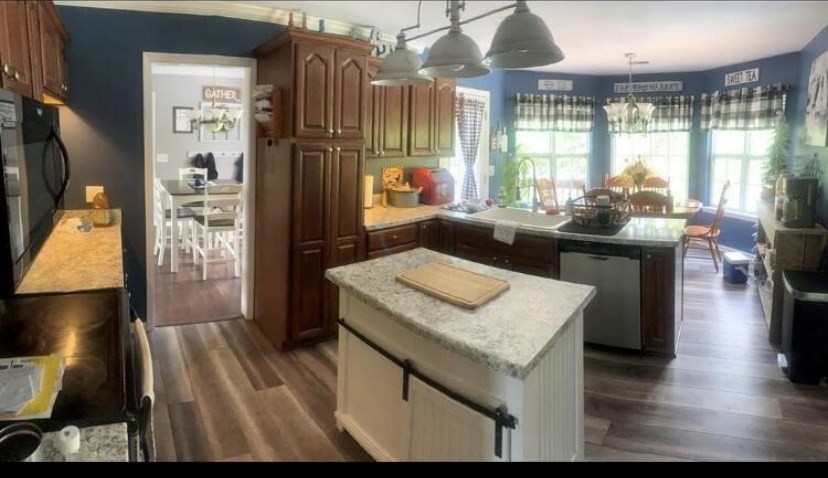 670 Armstrong Road Southeast Cleveland, TN 37323 - Photo 6 of 16 a kitchen with a table chairs and a wooden floor