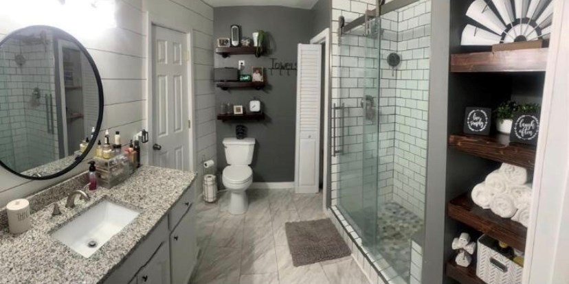 670 Armstrong Road Southeast Cleveland, TN 37323 - Photo 7 of 16 a bathroom with a granite countertop sink a toilet and shower