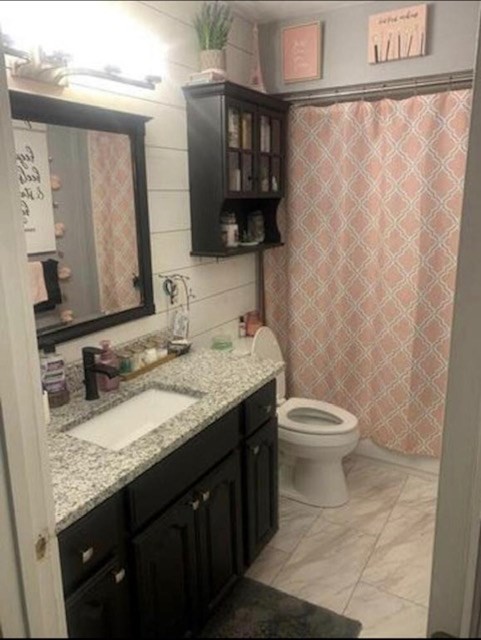 670 Armstrong Road Southeast Cleveland, TN 37323 - Photo 8 of 16 a bathroom with a granite countertop sink a toilet and a mirror