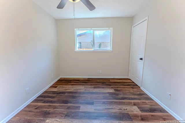 wooden floor in an empty room with a window