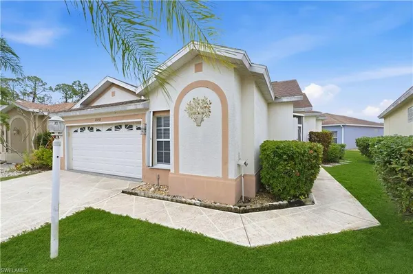 a front view of a house with a garden and plants
