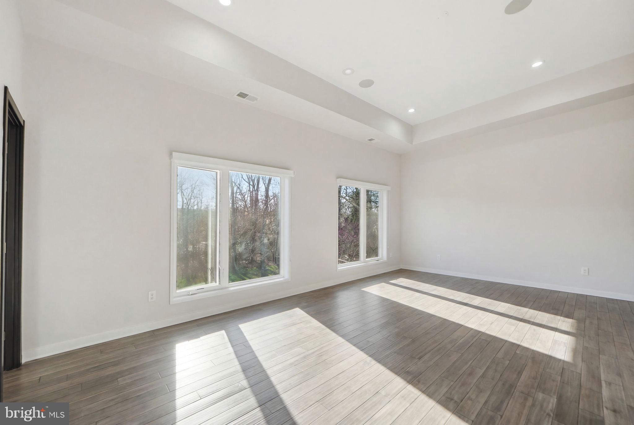2368 Hunter Mill Road Vienna, VA 22181 - Photo 65 of 74 an empty room with wooden floor and windows