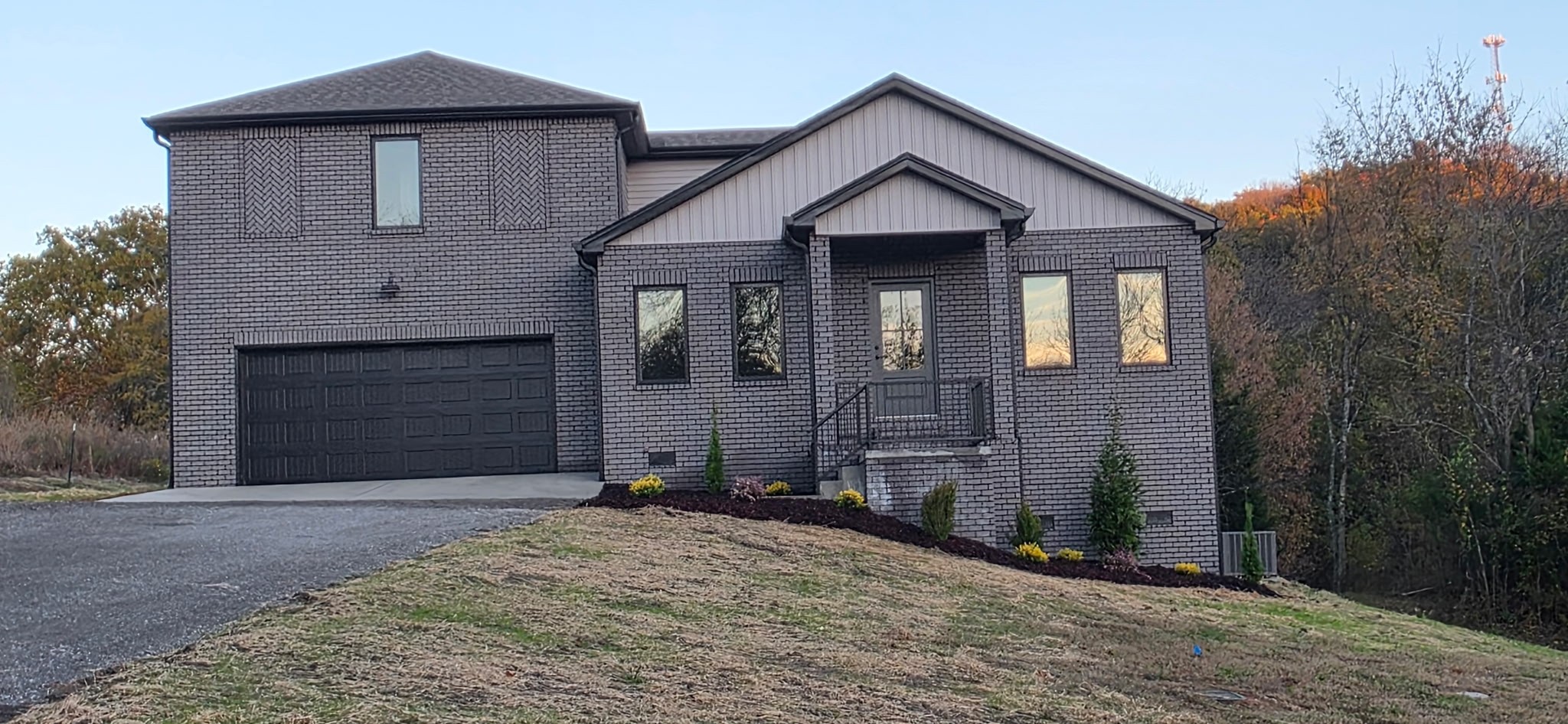 a front view of a house with a yard and garage