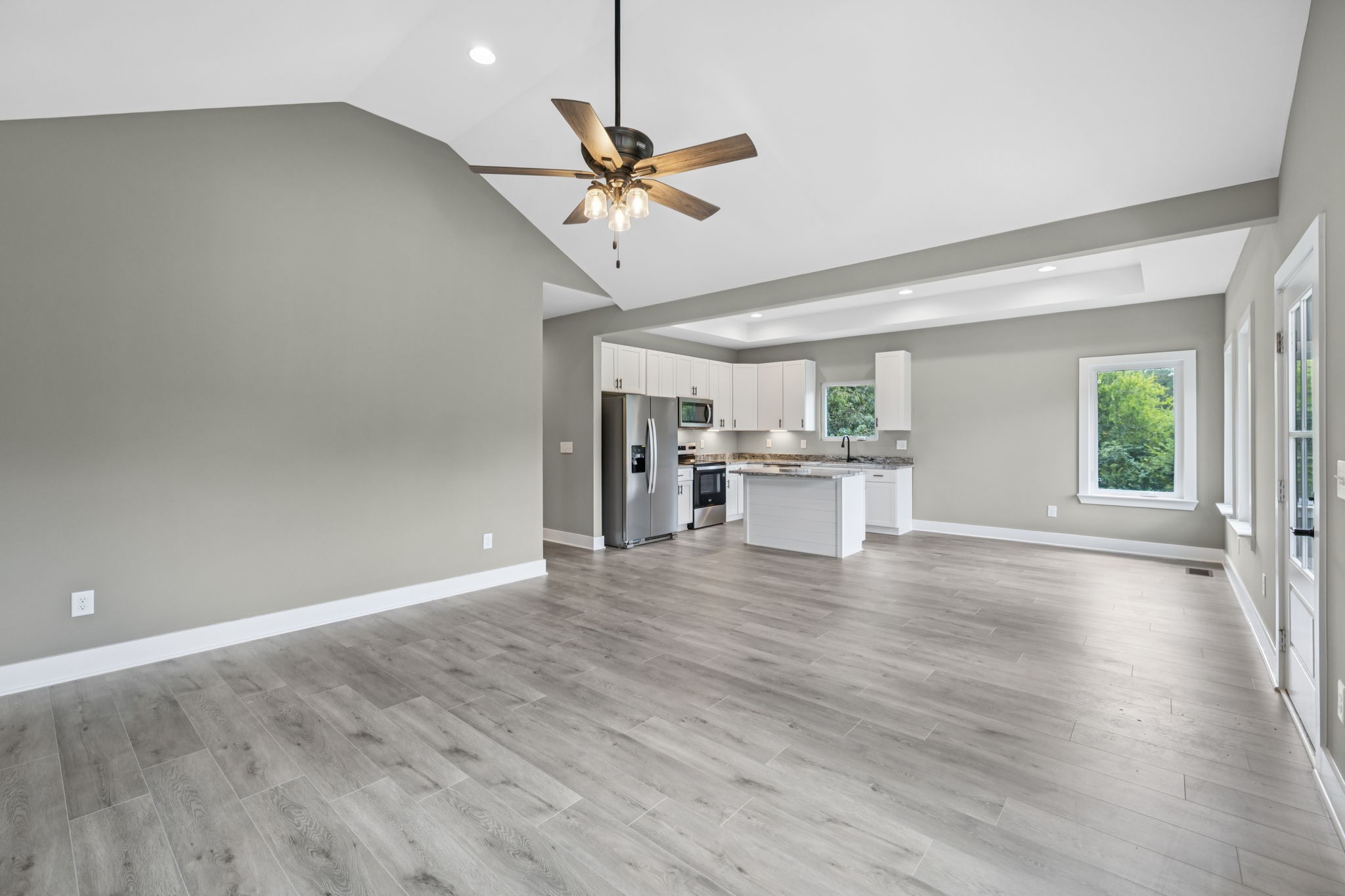 1825 Shop Springs Road Watertown, TN 37184 - Photo 5 of 25 an empty room with wooden floor fan and windows